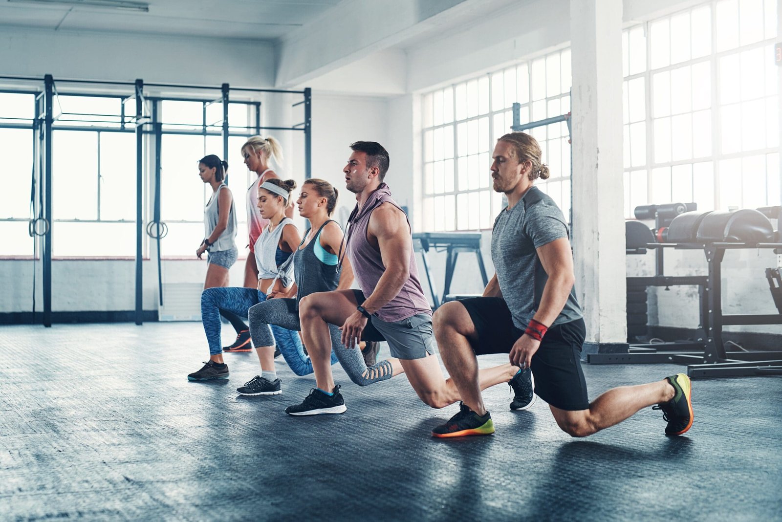 People,,Gym,And,Lunges,For,Wellness,Workout,Together,,Group,And Athlete recovering with various modern wellness therapies, showing dynamic movement and energy
